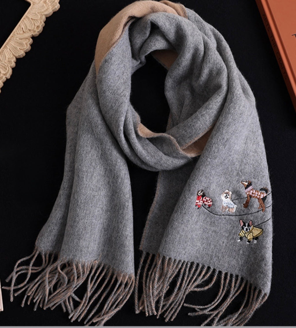 Gray scarf with embroidered dog designs on a black background